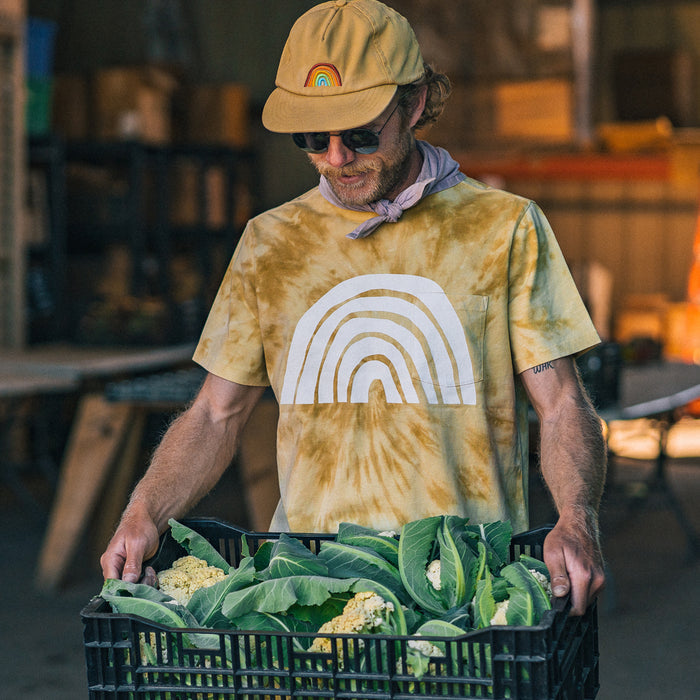 fit model holding a basket of produce in The Organic Cotton Tee in Ecology Center