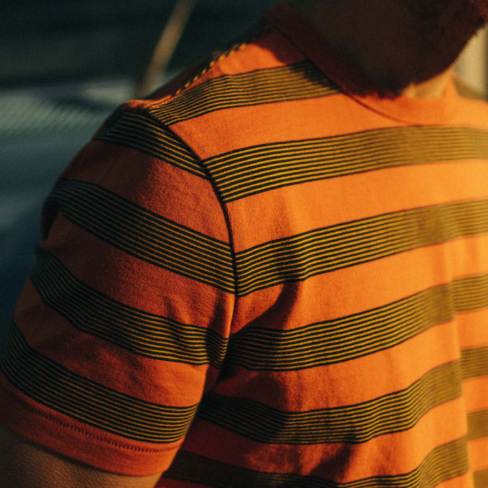 fit model wearing The Organic Cotton Tee in Rust Stripe