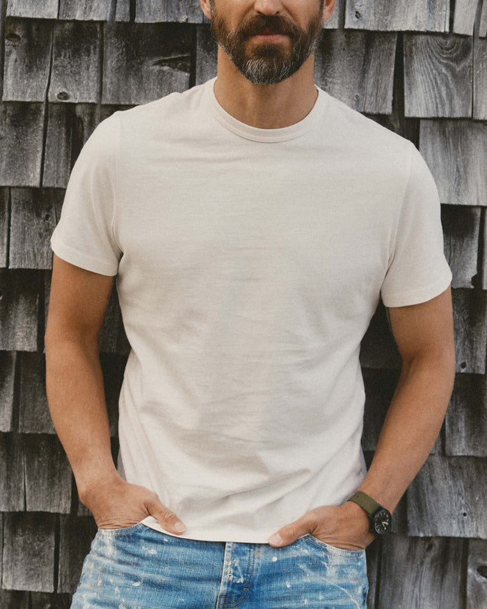 fit model walking wearing The Organic Cotton Tee in Vintage White