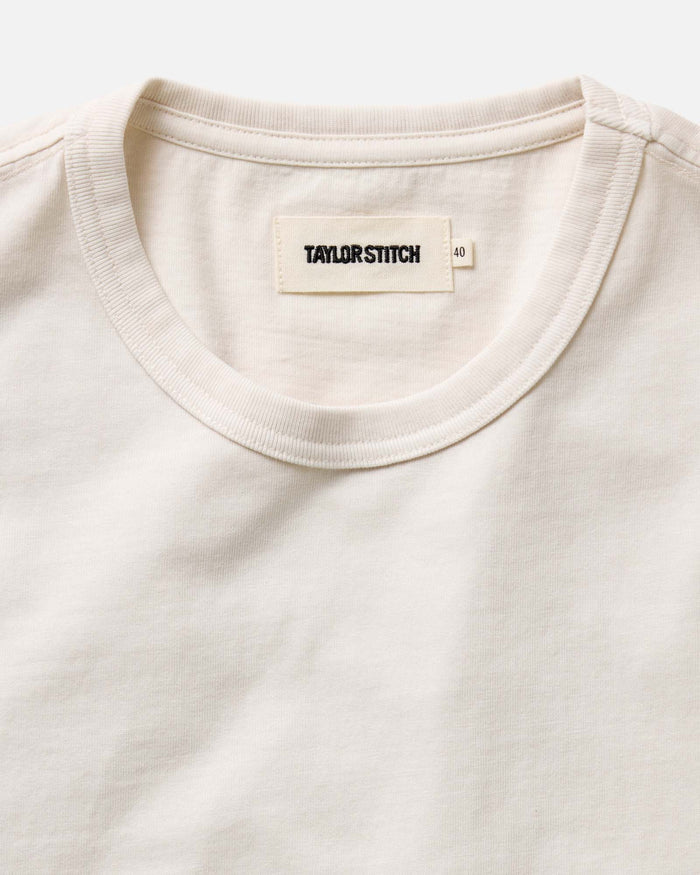 fit model showing off sleeves on The Organic Cotton Tee in Vintage White