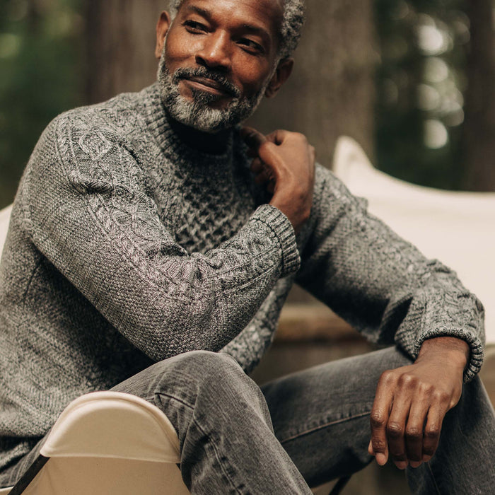 fit model sitting in The Orr Sweater in Marled Coal Merino