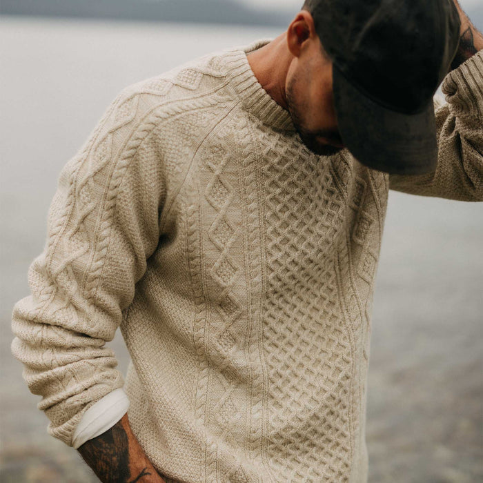 fit model posing in The Orr Sweater in Marled Oat Merino
