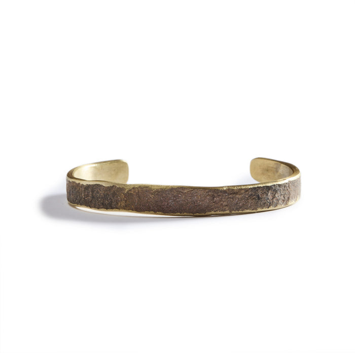 flatlay of The Hammered Cuff in Brass