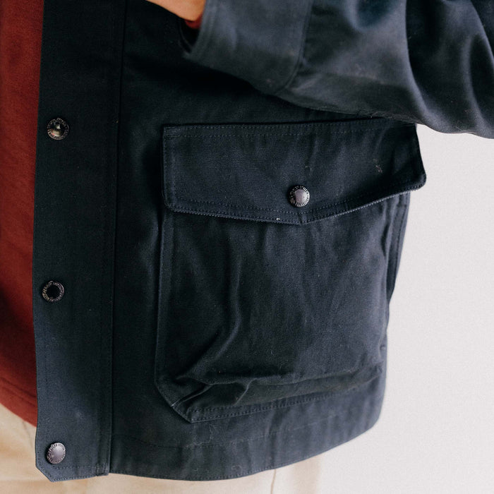 fit model posing in The Pathfinder Jacket in Dark Navy Dry Wax