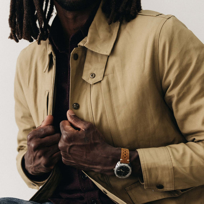 fit model adjusting The Pathfinder Jacket in Khaki Dry Wax