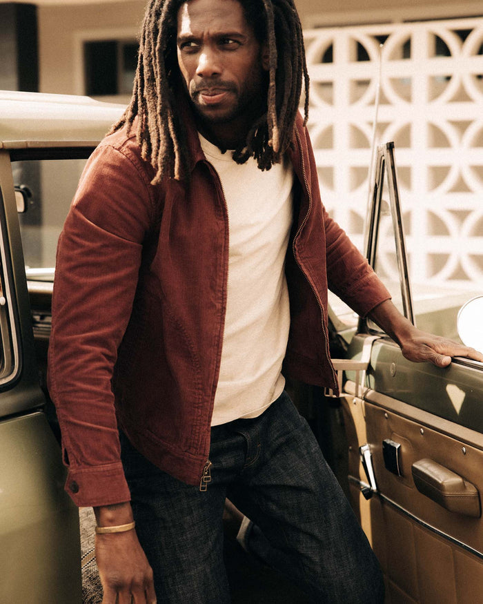 fit model getting out of a car wearing The Piston Jacket in Dried Cherry Corduroy