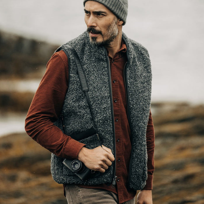 fit model walking wearing The Port Vest in Coal Marl Boucle Fleece