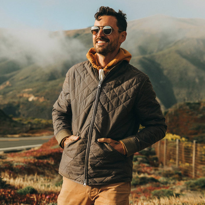 fit model wearing The Quilted Bomber Jacket in Espresso, hands in pockets
