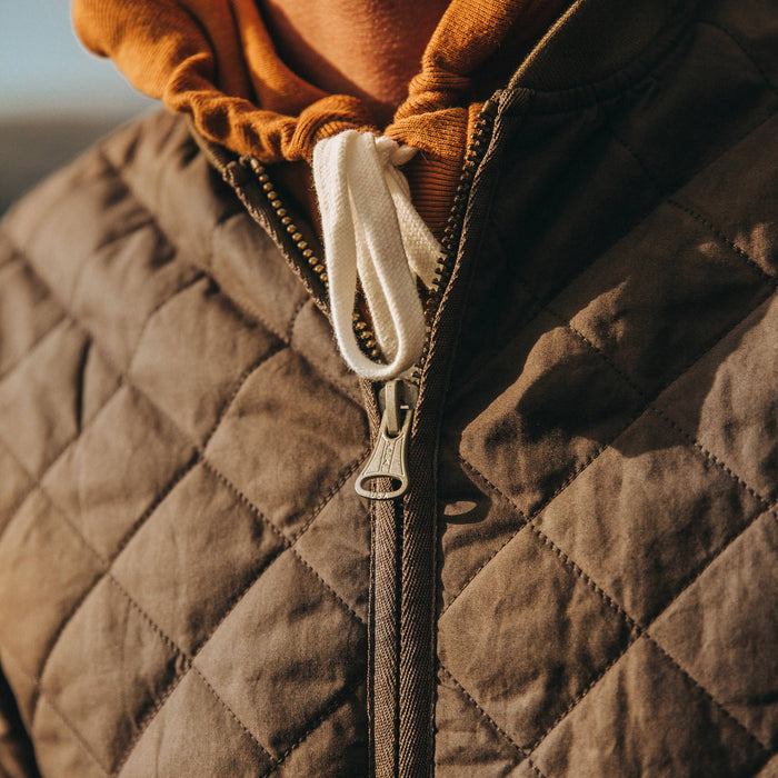 fit model wearing The Quilted Bomber Jacket in Espresso, zipper