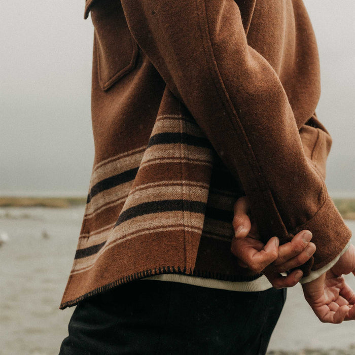 fit model showing off the cuffs The Ranger Shirt in Tarnished Copper Blanket Stripe