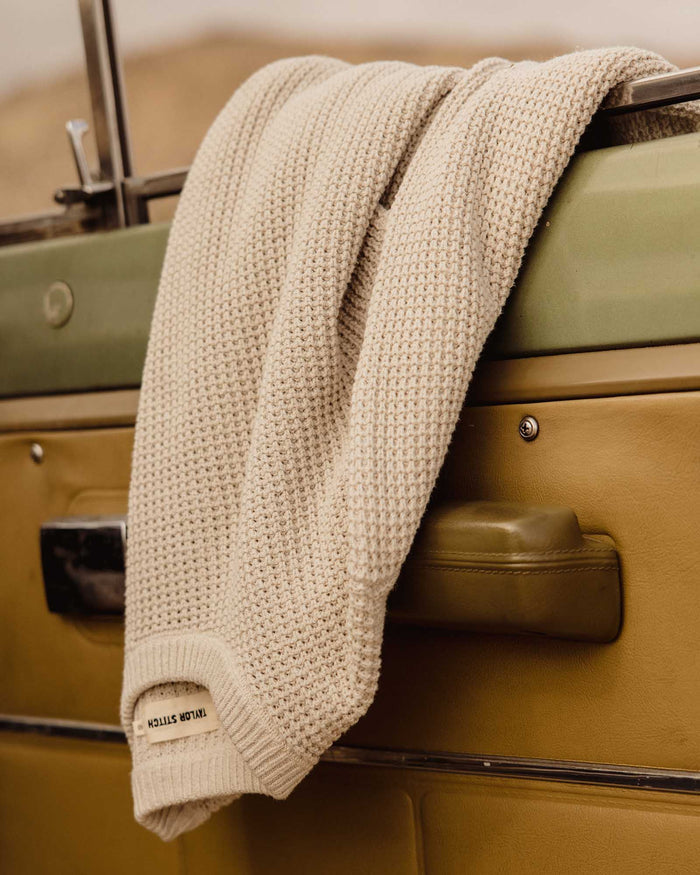 editorial image of The Ranger Sweater in Heather Fog Linen Waffle hanging on a car