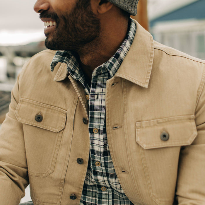 fit model wearing The Reserve Shirt in Khaki Herringbone over a plaid shirt