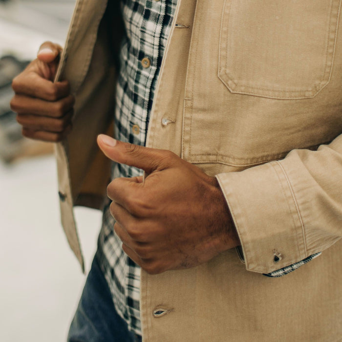 fit model holding open The Reserve Shirt in Khaki Herringbone