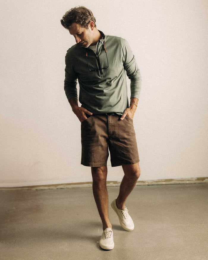 fit model posing in The Ridgeline Merino Half Zip in Field Olive