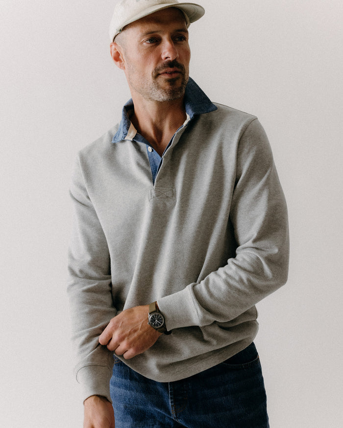 fit model adjusting the cuffs on The Rugby Shirt in Heather Grey
