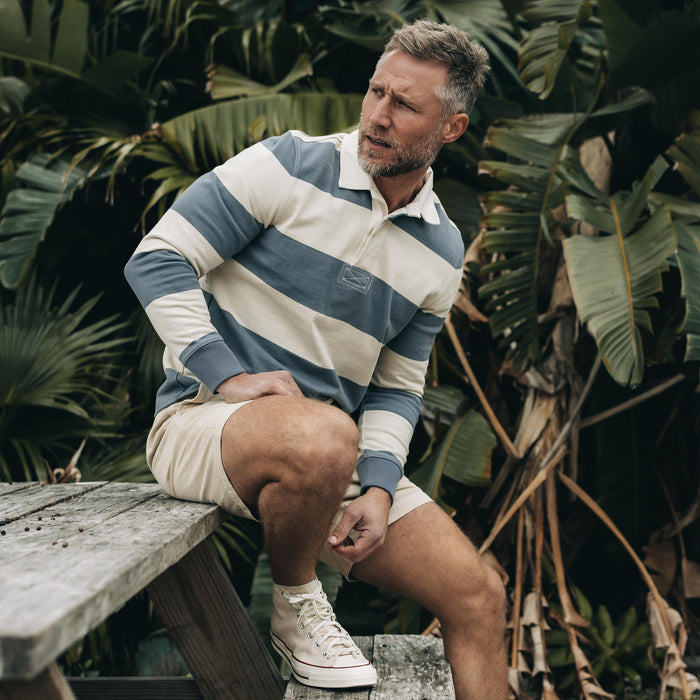 fit model sitting wearing The Rugby Shirt in Storm Stripe