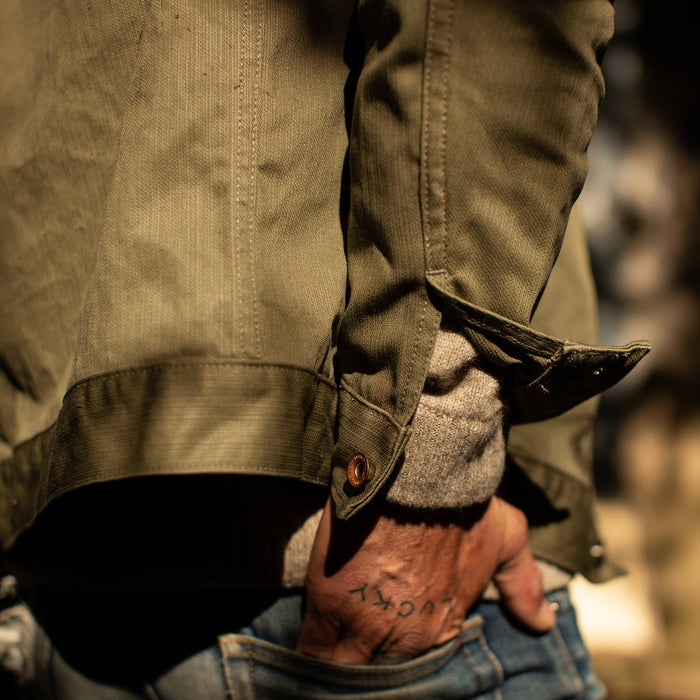 fit model wearing The Ryder Jacket in Yoshiwa Mills Olive with hand in back pocket