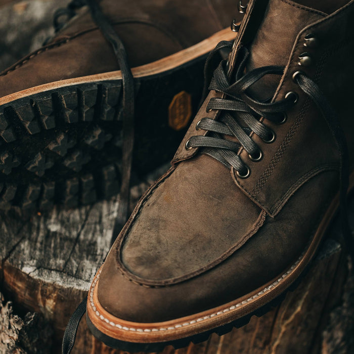 material shot of boots on log