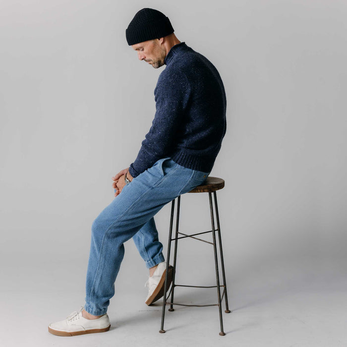 fit model sitting wearing The Seafarer Sweater in Atlantic Blue Donegal