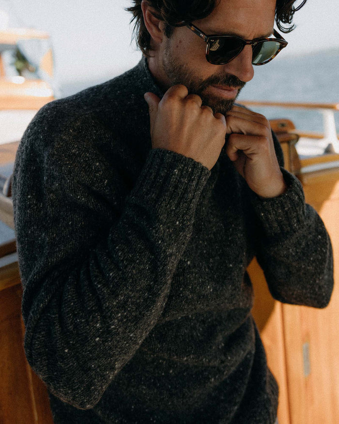 fit model posing in The Seafarer Sweater in Charcoal Donegal