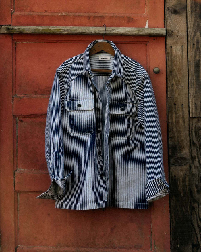 editorial image of The Shop Shirt in Rinsed Indigo Selvedge hanging