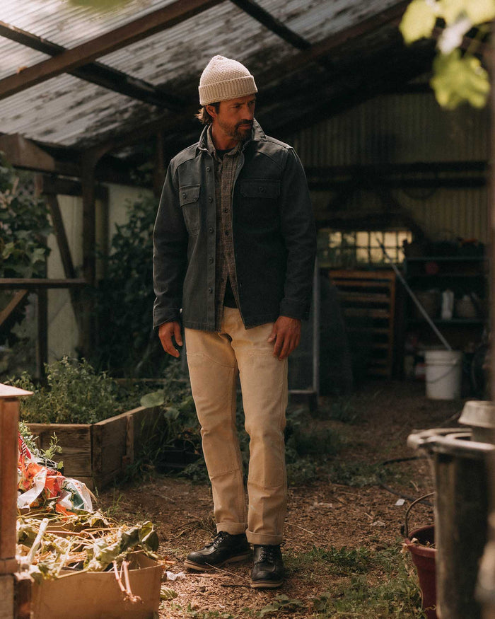 fit model adjusting the sleeves on The Shop Shirt in Navy Chipped Canvas