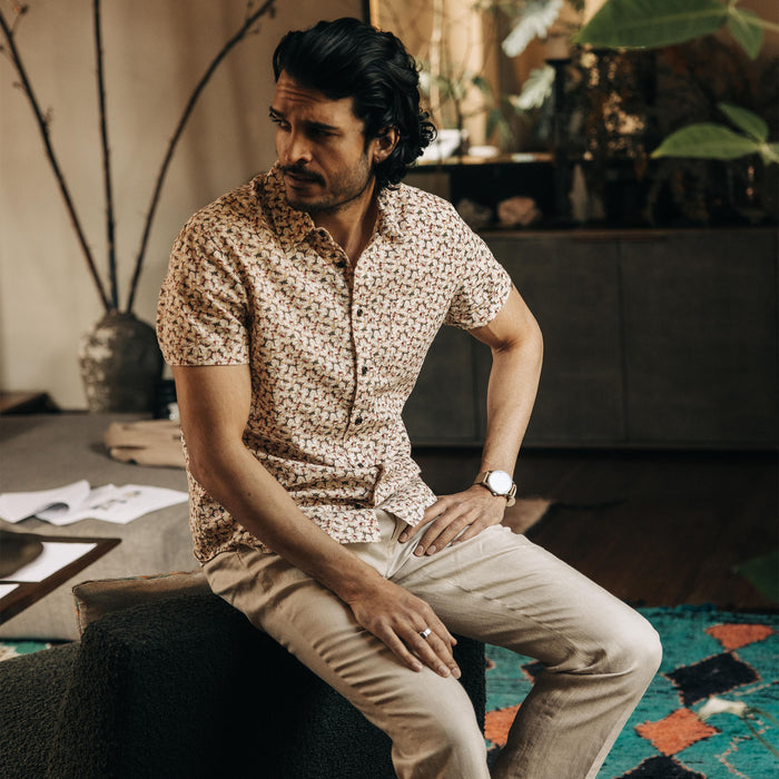 fit model sitting on a chair in The Short Sleeve California in Coastal Flora