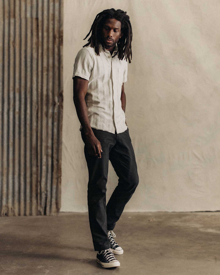 fit model adjusting the buttons on The Short Sleeve California in Heather Ash Pointelle Stripe