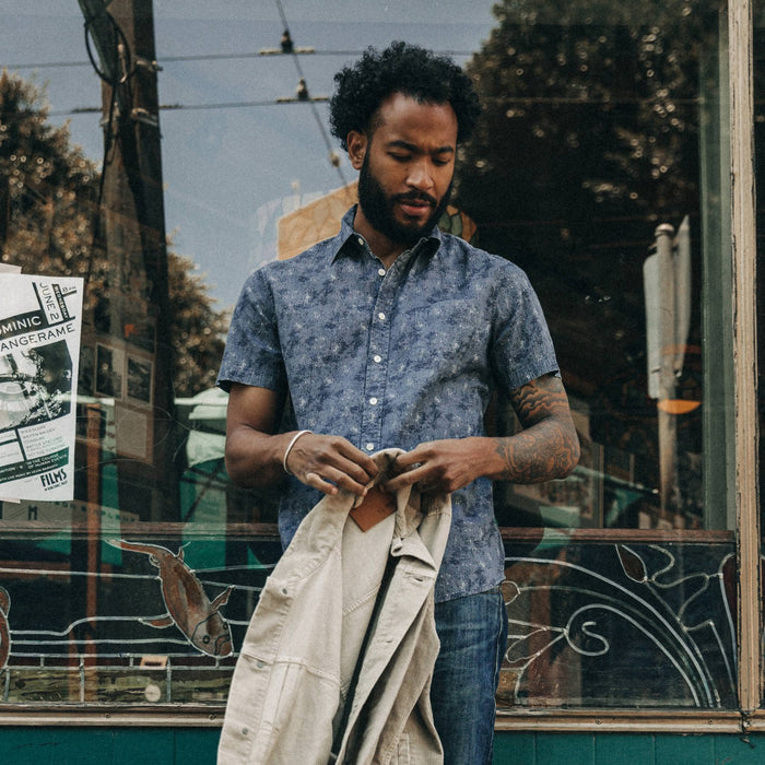 fit model wearing The Short Sleeve California in Ocean Sketch, holding jacket