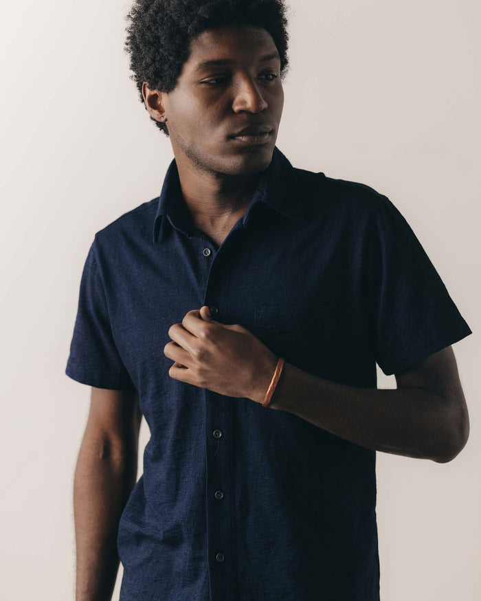 fit model sitting wearing The Short Sleeve California in Rinsed Indigo Slub