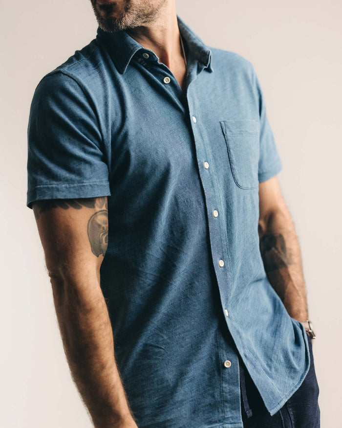 fit model sitting wearing The Short Sleeve California in Washed Indigo Slub