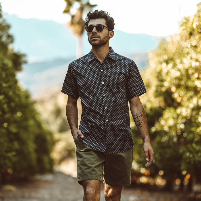 Our fit model wearing shorts in an orange orchard