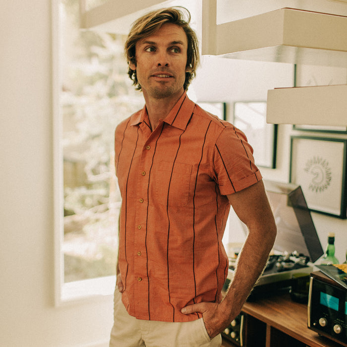 fit model posing by a turntable in The Short Sleeve Hawthorne in Rust Stripe