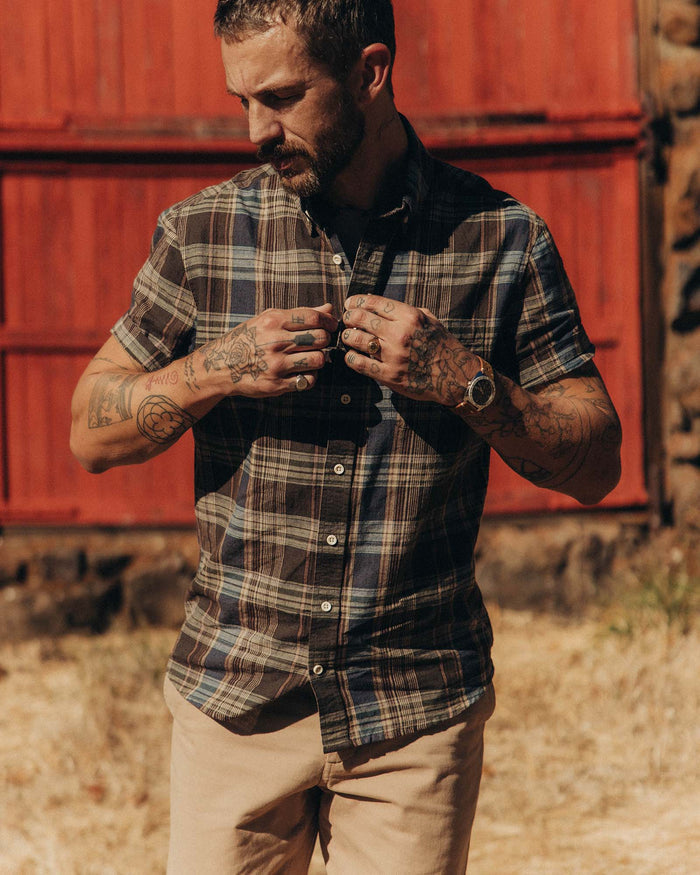 fit model buttoning up The Short Sleeve Jack in Atlantic Blue Plaid