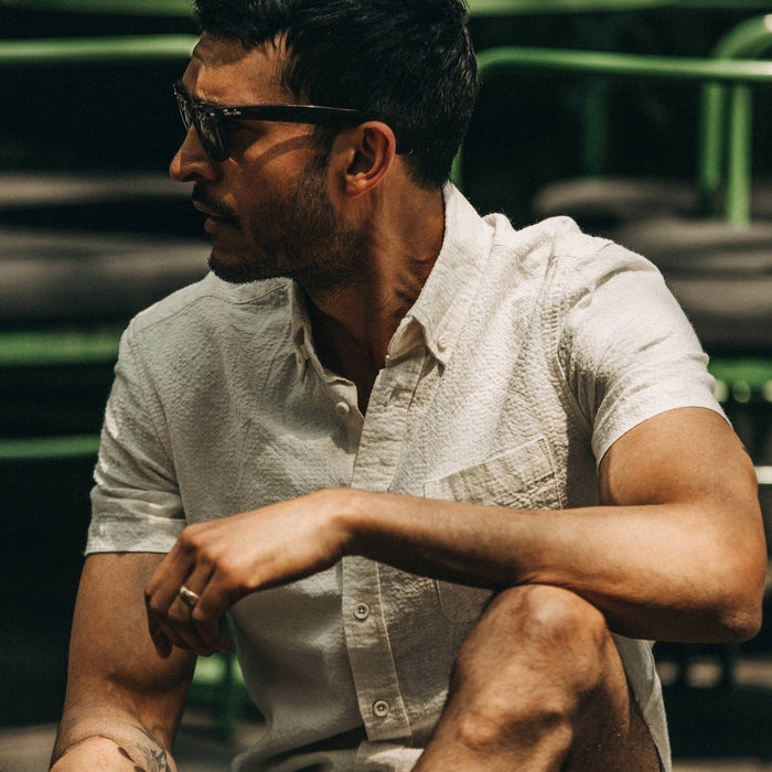 fit model wearing flatlay of The Short Sleeve Jack in Natural Ramie Grid, looking left, sitting