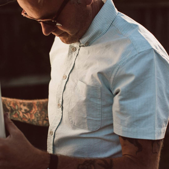 Our fit model wearing The Short Sleeve Jack in Teal University Stripe from Taylor Stitch.