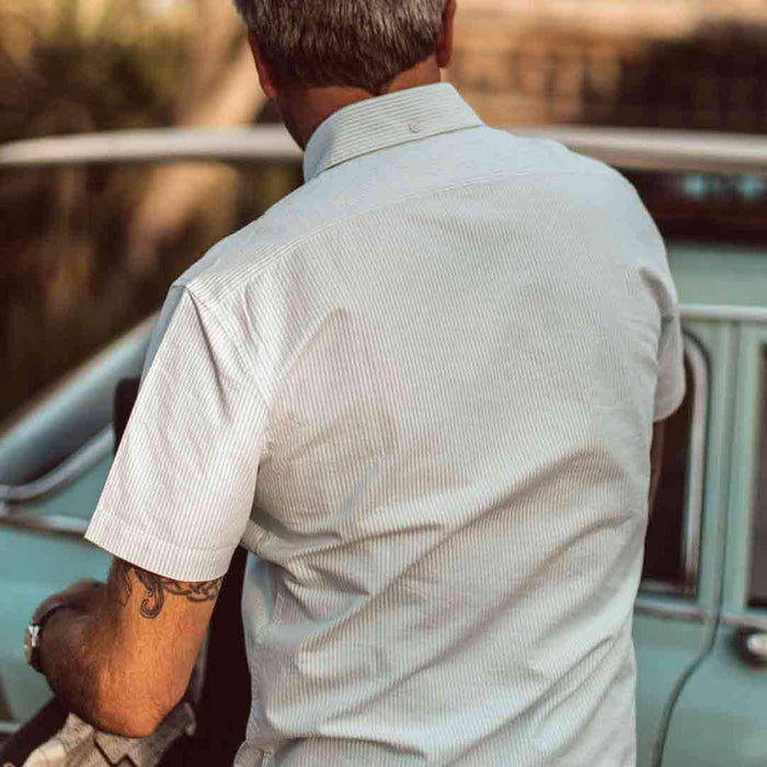 Our fit model wearing The Short Sleeve Jack in Teal University Stripe from Taylor Stitch.
