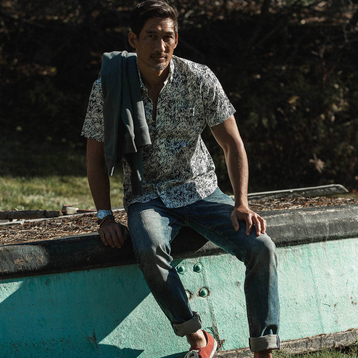 fit model wearing The Short Sleeve Jack in Whitewater, sitting, jeans cuffed