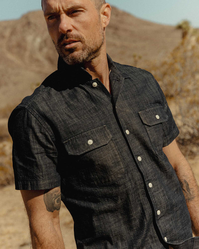 fit model posing in The Short Sleeve Mechanic Shirt in Rinsed Indigo Denim