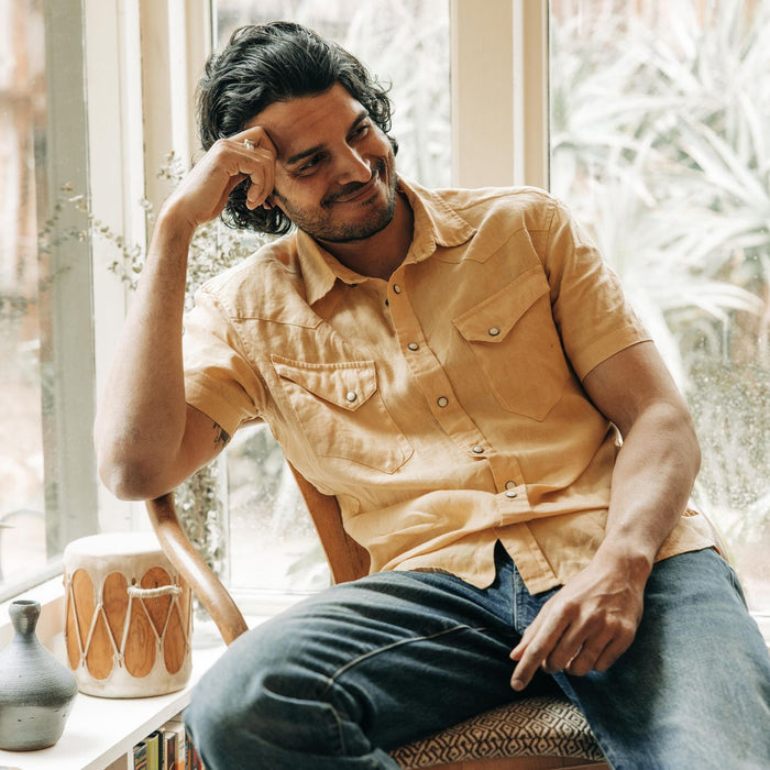 fit model sitting in The Short Sleeve Western in Oak