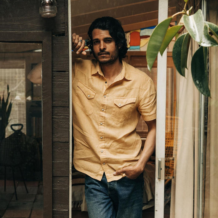 fit model standing by the doorway in The Short Sleeve Western in Oak