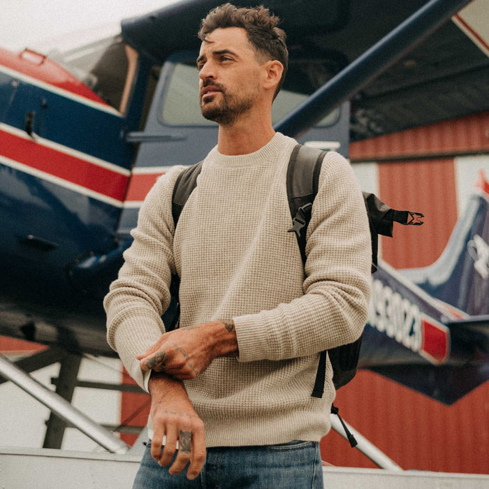fit model adjusting the cuffs on The Sidecountry Crew in Heather Fog Merino Waffle
