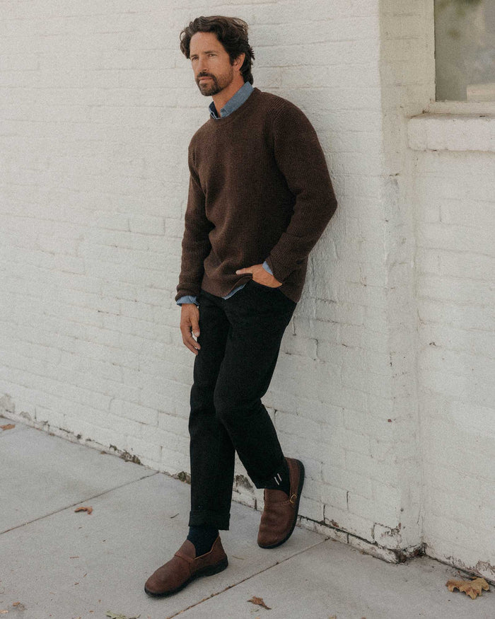fit model leaning against the wall wearing The Sidecountry Crew in Heather Marsh Merino Waffle