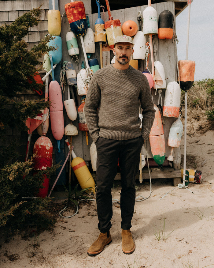 fit model with his hands in his pockets wearing The Slim Foundation Pant in Organic Faded Black