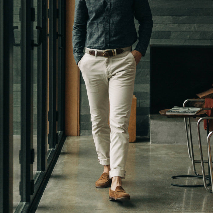 fit model wearing The Slim Foundation Pant in Organic Stone with a shirt tucked in
