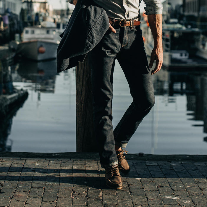 fit model wearing The Slim Jean in Organic Selvage, cuffed with shoes, walking near water