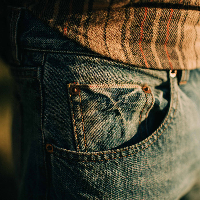 fit model showing the pocket detail of The Slim Jean in Patch Wash Selvage