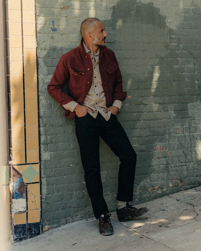 fit model standing wearing The Slim Jean in Rigid Black Organic Selvedge