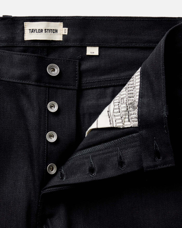 fit model walking wearing The Slim Jean in Rigid Black Organic Selvedge