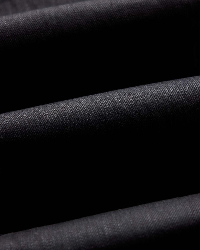 folded flatlay of the back of The Slim Jean in Rigid Black Organic Selvedge